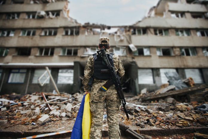 Ukrainian,Military,Woman,With,The,Ukrainian,Flag,In,Her,Hands